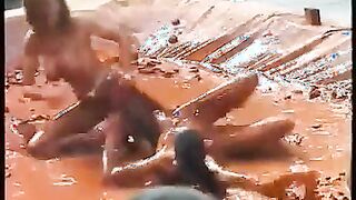 Two Topless Girls Wrestle in Clay